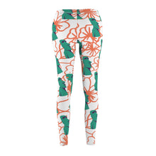 Load image into Gallery viewer, Tiki Flower Leggings with a white background.  Orange outlined hibiscus flowers and teal green  Easter Island statue heads in a repeating pattern.
