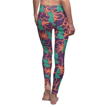 Load image into Gallery viewer, Tiki Flower Leggings with a dark purple background.  Orange outlined hibiscus flowers and teal green  Easter Island statue heads in a repeating pattern.
