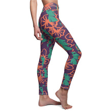 Load image into Gallery viewer, Tiki Flower Leggings with a dark purple background.  Orange outlined hibiscus flowers and teal green  Easter Island statue heads in a repeating pattern.
