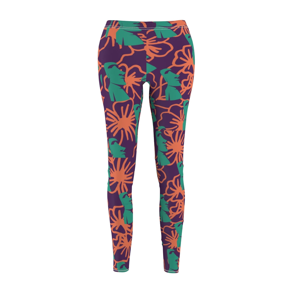 Tiki Flower Leggings with a dark purple background.  Orange outlined hibiscus flowers and teal green  Easter Island statue heads in a repeating pattern.