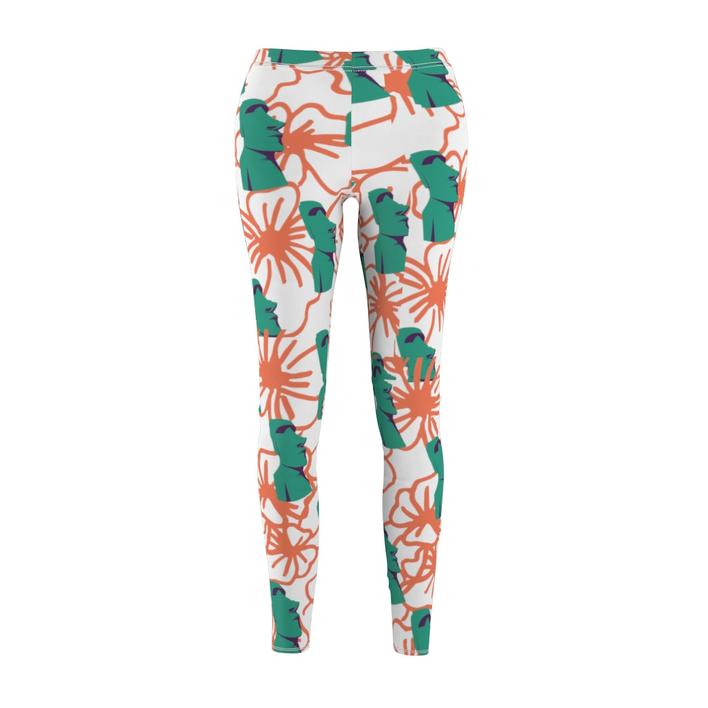 Tiki Flower Leggings with a white background.  Orange outlined hibiscus flowers and teal green  Easter Island statue heads in a repeating pattern.